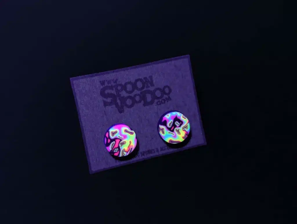 psychedelic uv ear stud on earring card under uv light, trippy festival jewelry 